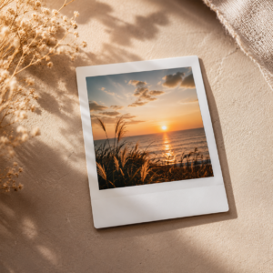 Studio-quality polaroid photo of a happy family sitting on a beach during sunset with warm aesthetic lighting and vintage background styling.